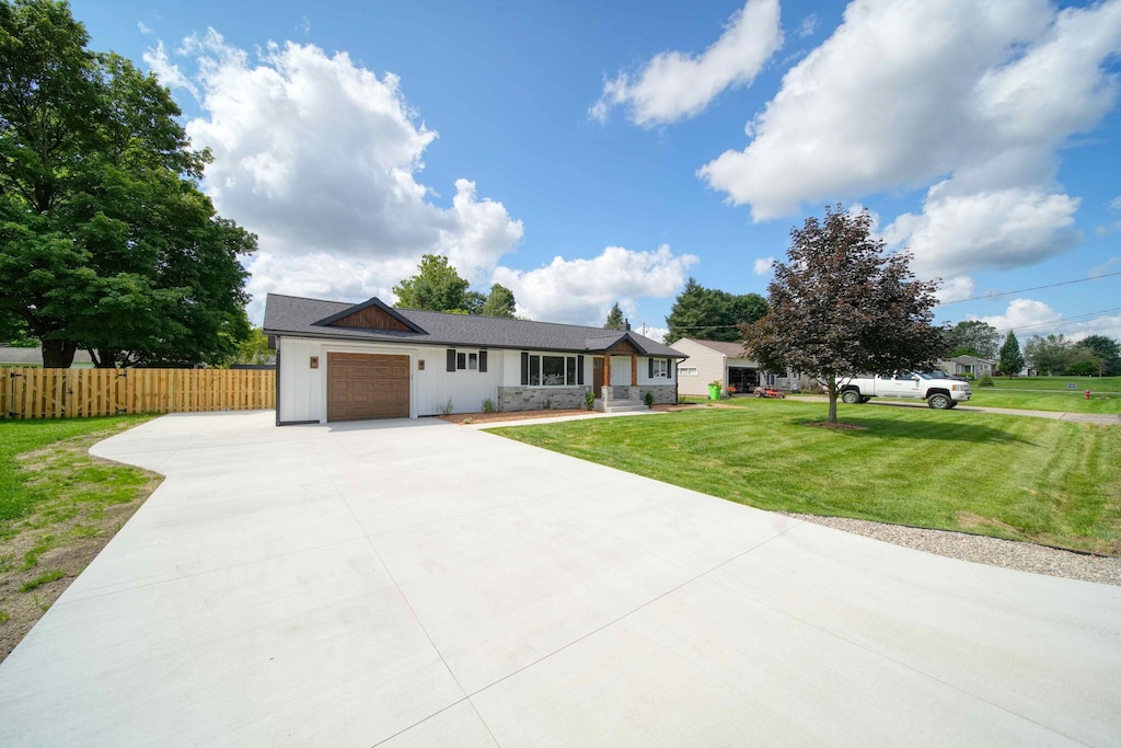 ranch-style house with a garage and a front yard