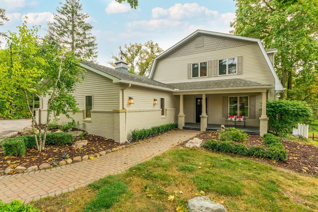 18760 Valencia St, Northville, MI 48168 - dutch colonial with a gambrel roof, a front yard, brick siding, a shingled roof, and a porch