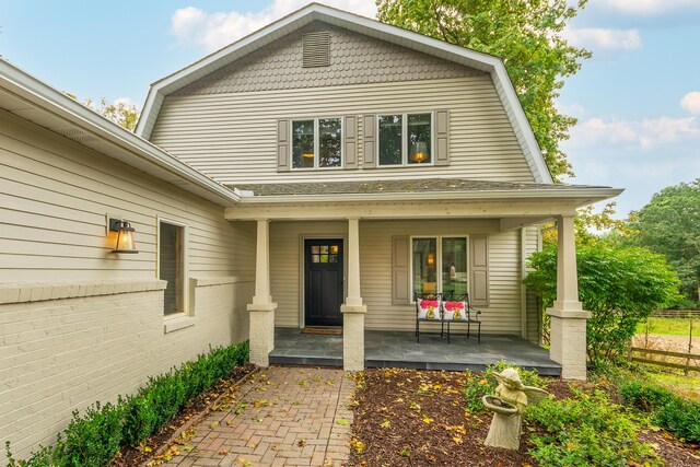 18760 Valencia St, Northville, MI 48168 - doorway to property with a gambrel roof and a porch