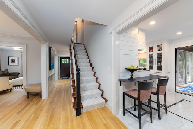 18760 Valencia St, Northville, MI 48168 - stairs featuring wood finished floors, ornamental molding, and recessed lighting