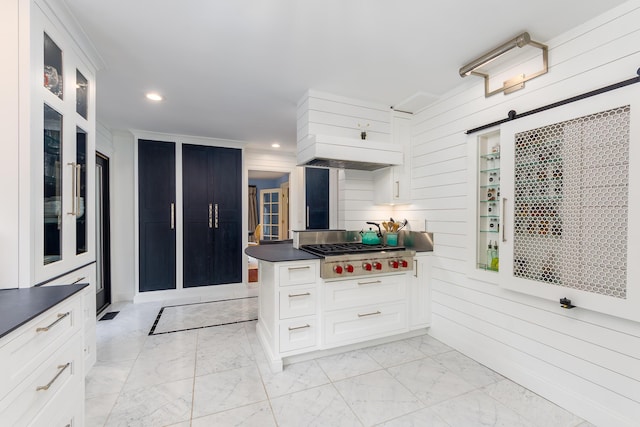 18760 Valencia St, Northville, MI 48168 - kitchen featuring glass insert cabinets, stainless steel gas stovetop, custom exhaust hood, marble finish floor, and dark countertops