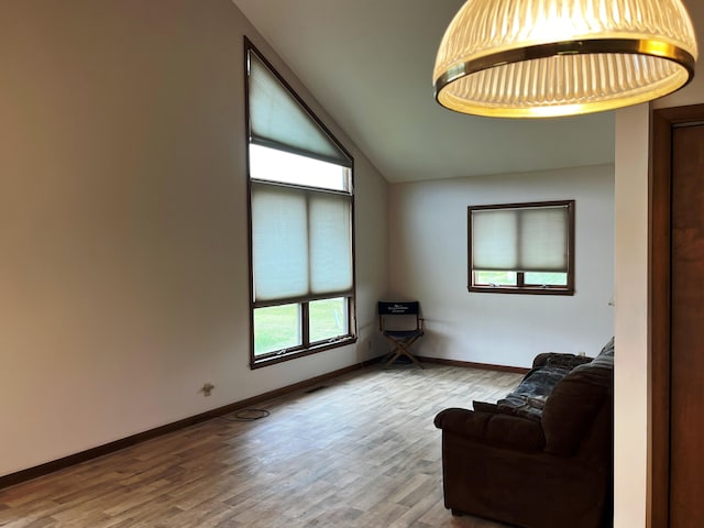 sitting room with lofted ceiling and hardwood / wood-style floors