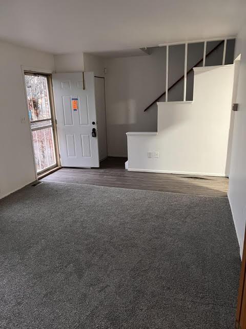 unfurnished living room featuring carpet floors