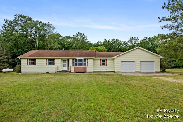 ranch-style home with a garage and a front lawn