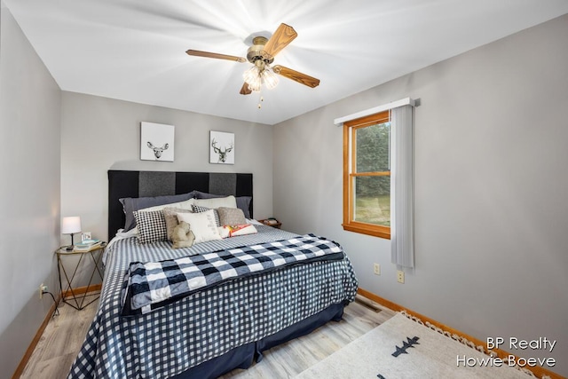 bedroom with ceiling fan and light hardwood / wood-style floors