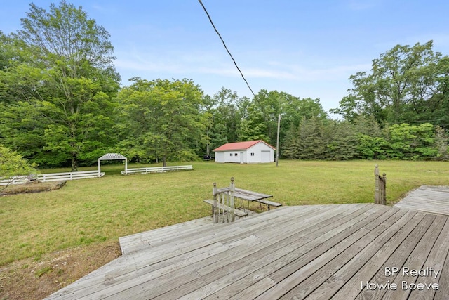 wooden deck featuring a yard and an outbuilding