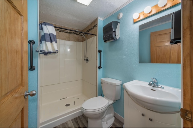 bathroom with walk in shower, a textured ceiling, toilet, vanity, and hardwood / wood-style flooring