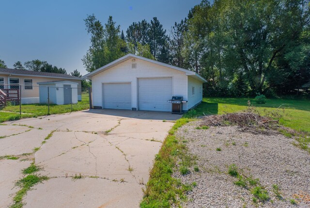 garage featuring a lawn