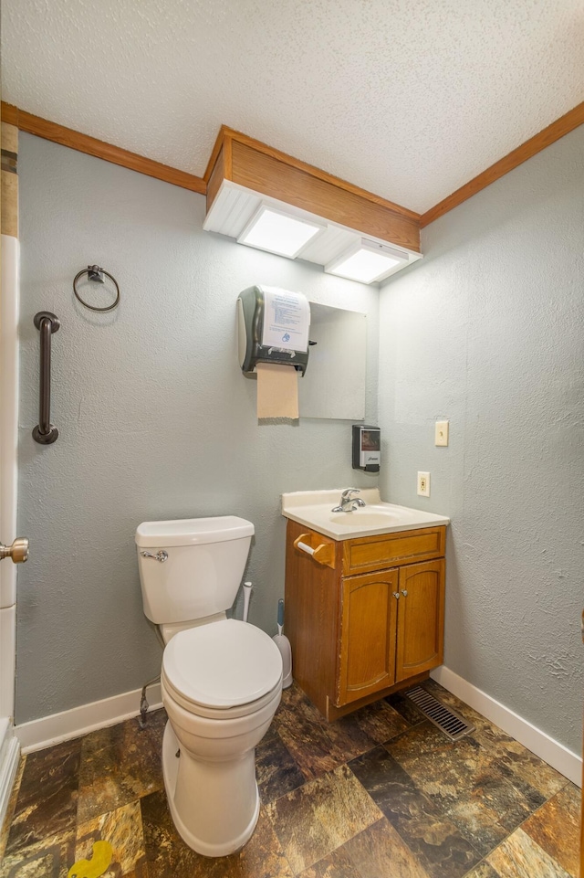 bathroom with vanity, a textured ceiling, toilet, and tile patterned floors