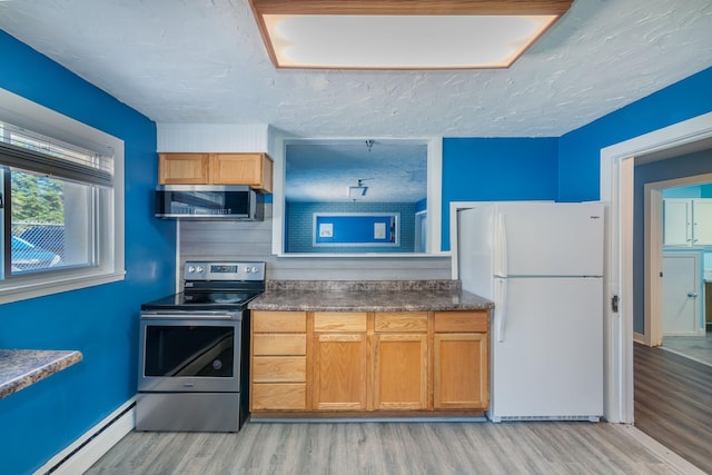 kitchen featuring light hardwood / wood-style floors, appliances with stainless steel finishes, and baseboard heating