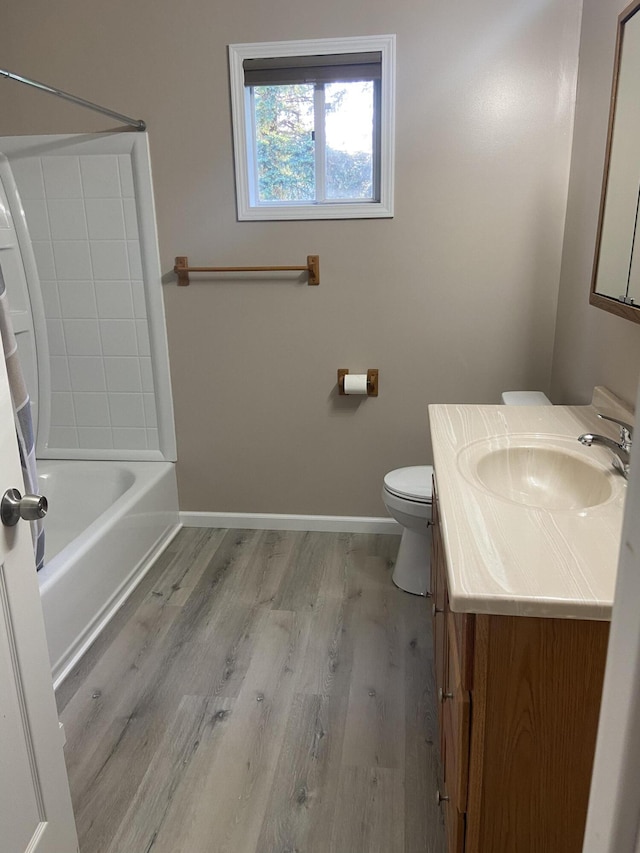 full bathroom featuring vanity, bathing tub / shower combination, hardwood / wood-style floors, and toilet