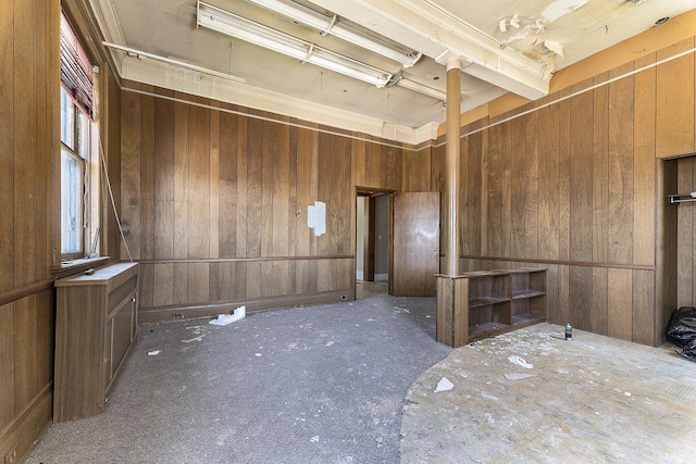 spare room featuring wooden walls