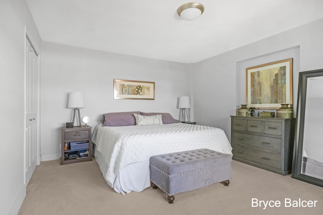 bedroom with light colored carpet and a closet