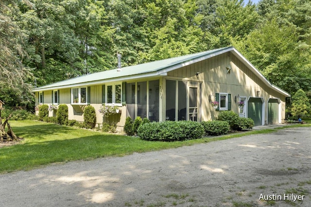 view of property exterior featuring a garage and a yard