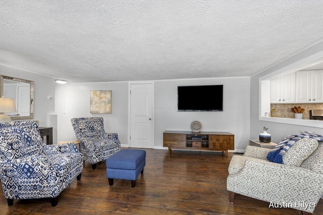 living room featuring dark wood-type flooring and a textured ceiling