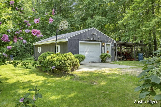 view of side of property with an outbuilding, a garage, and a yard