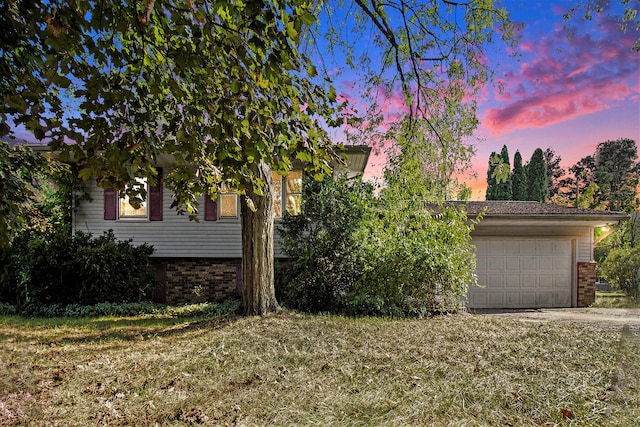 view of front of house with a yard and a garage