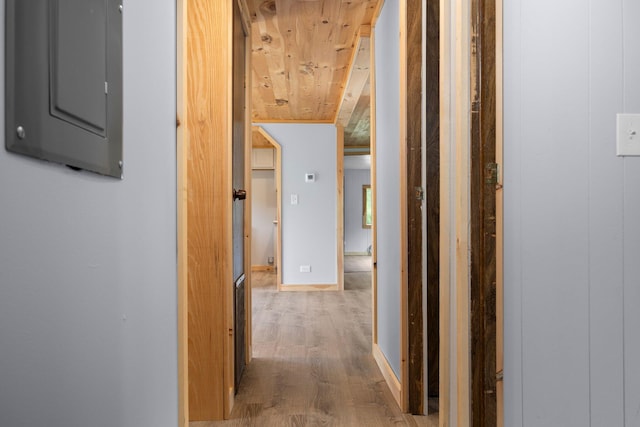 hall featuring wood-type flooring, electric panel, and wooden ceiling