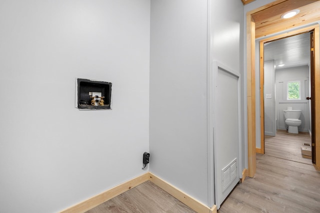 washroom with hookup for a washing machine and light wood-type flooring