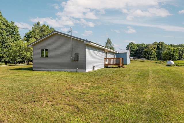 view of home's exterior featuring a deck and a lawn