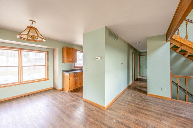 kitchen with pendant lighting and light hardwood / wood-style floors