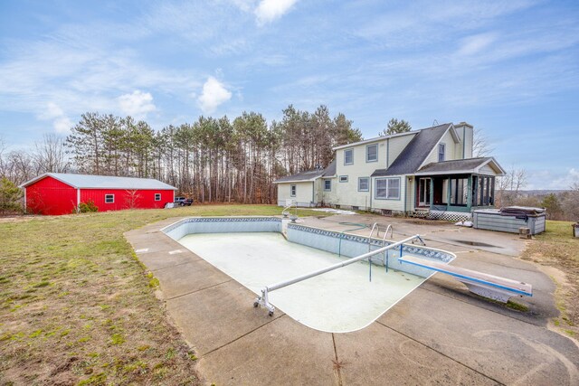 view of swimming pool with a yard, a diving board, a patio area, and a sunroom