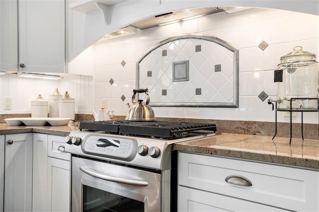 kitchen with white cabinetry, decorative backsplash, stainless steel range with gas cooktop, and stone counters