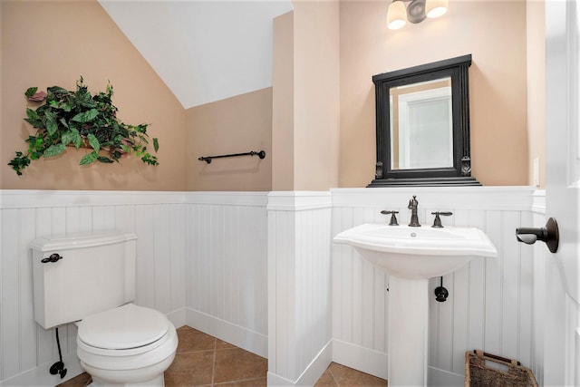 bathroom featuring tile patterned floors, toilet, and vaulted ceiling