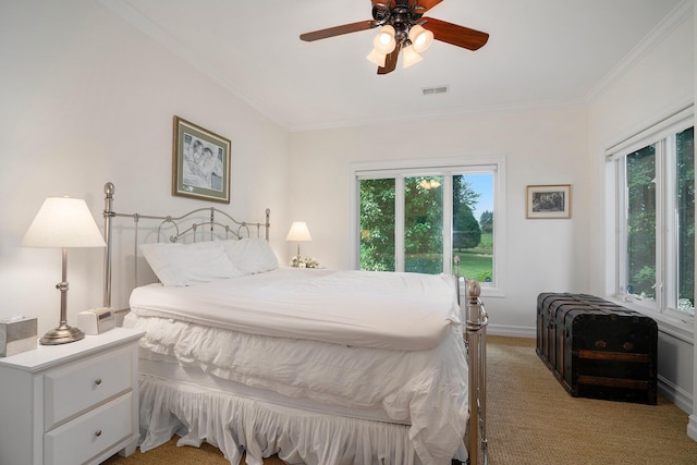 bedroom with ornamental molding, light colored carpet, and ceiling fan