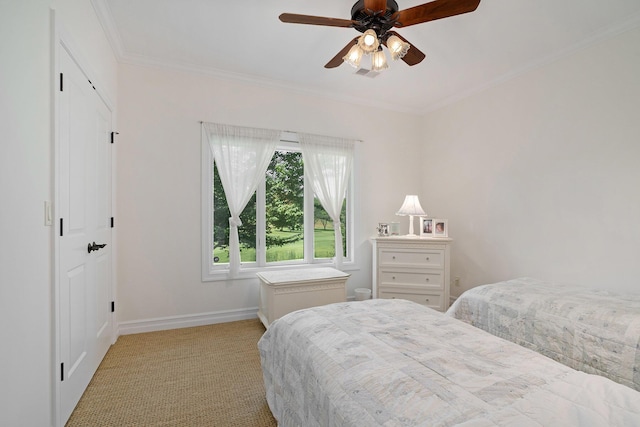 bedroom featuring crown molding, ceiling fan, and light colored carpet