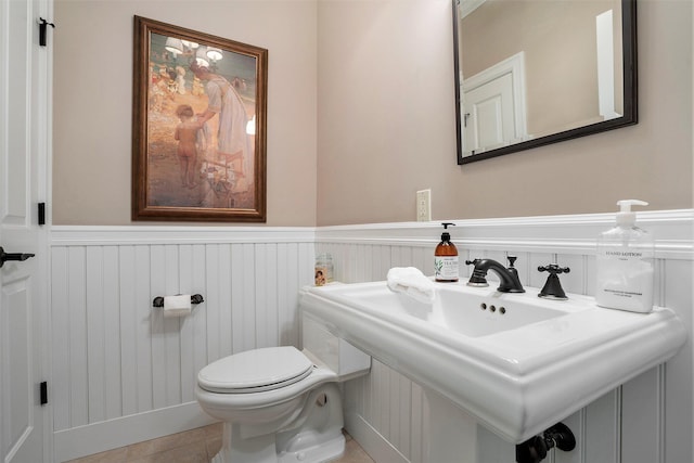 bathroom featuring tile patterned flooring, sink, and toilet