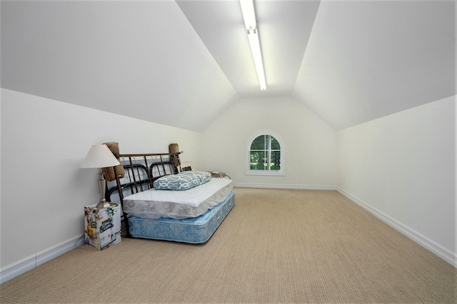 carpeted bedroom featuring lofted ceiling