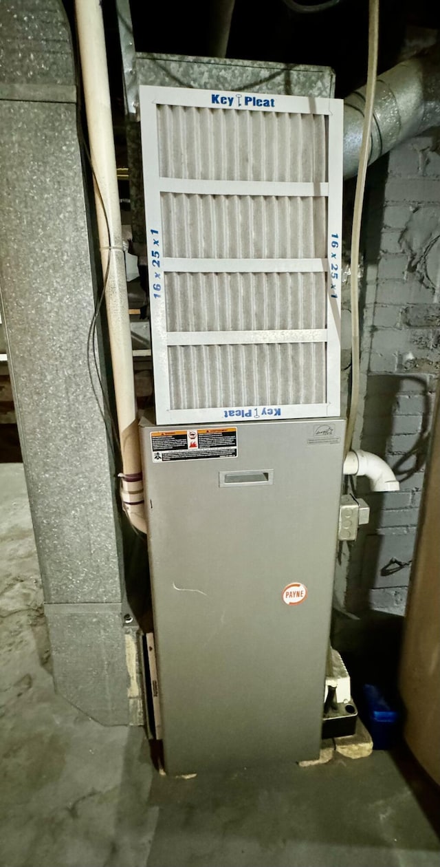 utility room featuring heating unit