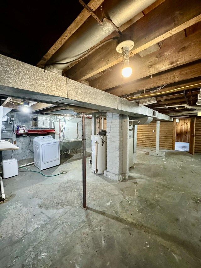 basement featuring gas water heater and washer / dryer