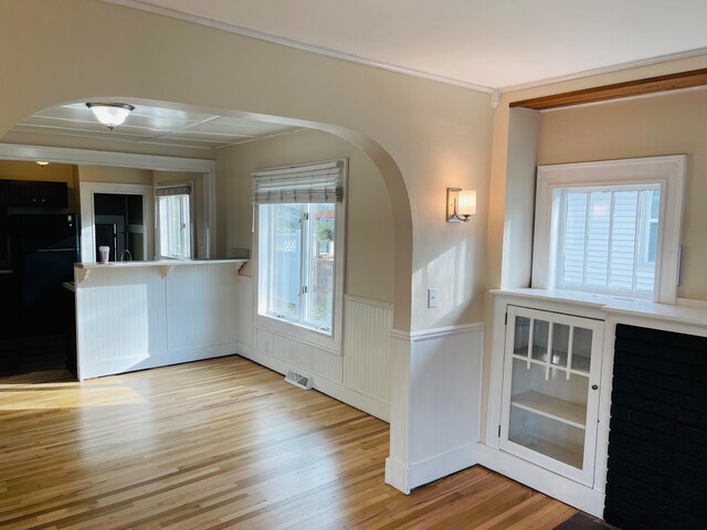 foyer featuring ornamental molding and light hardwood / wood-style floors