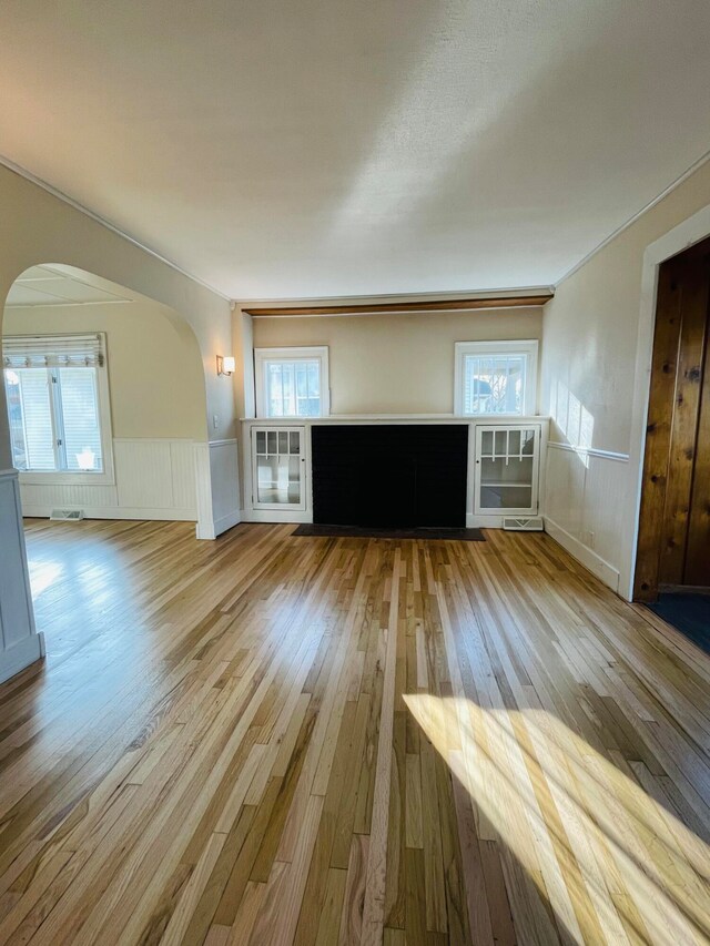 unfurnished living room with plenty of natural light and light wood-type flooring