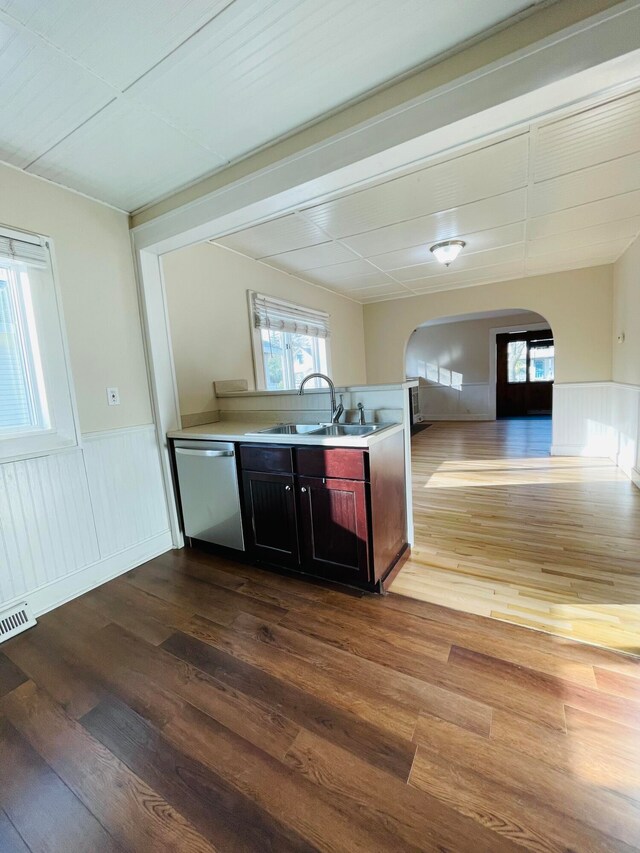 kitchen featuring dishwasher, sink, and light wood-type flooring