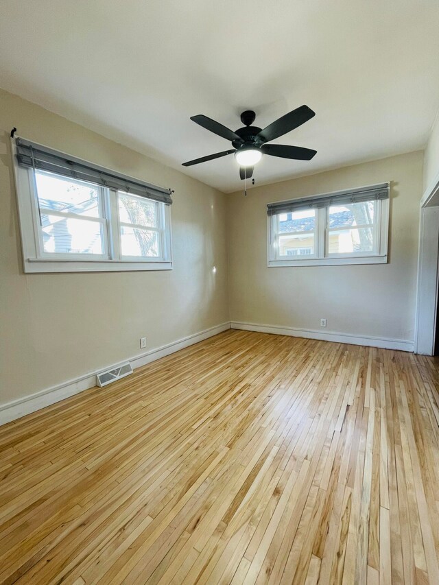 unfurnished room with ceiling fan and light hardwood / wood-style flooring