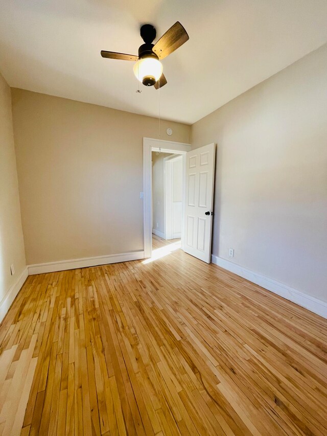 spare room with ceiling fan and light hardwood / wood-style floors