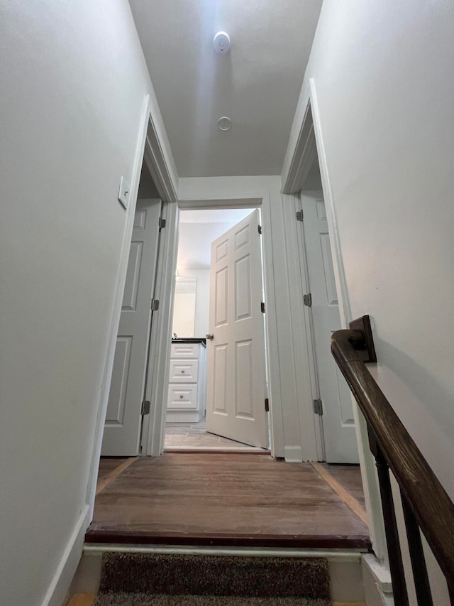 stairs with hardwood / wood-style flooring