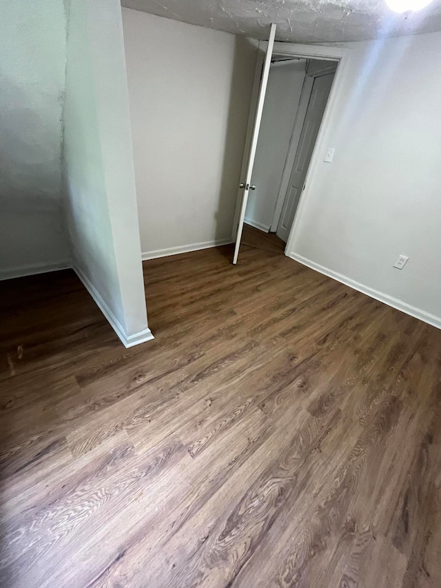 unfurnished bedroom with hardwood / wood-style flooring and a closet