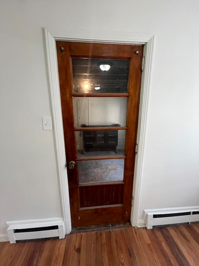 room details featuring hardwood / wood-style flooring and a baseboard heating unit