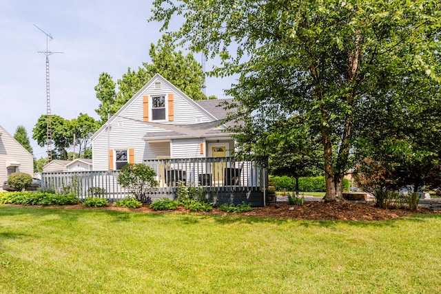 back of house with a deck and a yard