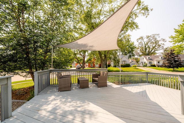 wooden terrace with a residential view and a lawn