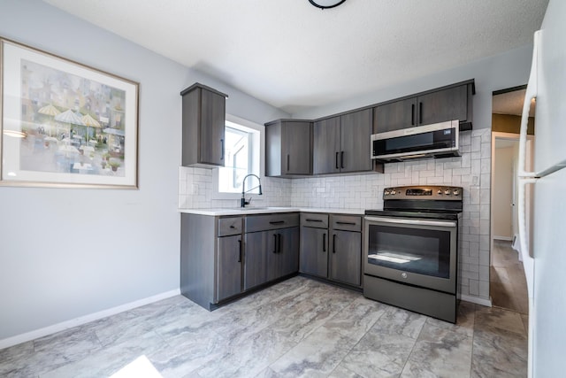 kitchen with sink, backsplash, and appliances with stainless steel finishes