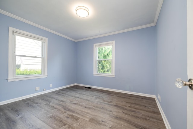 spare room with crown molding and wood-type flooring