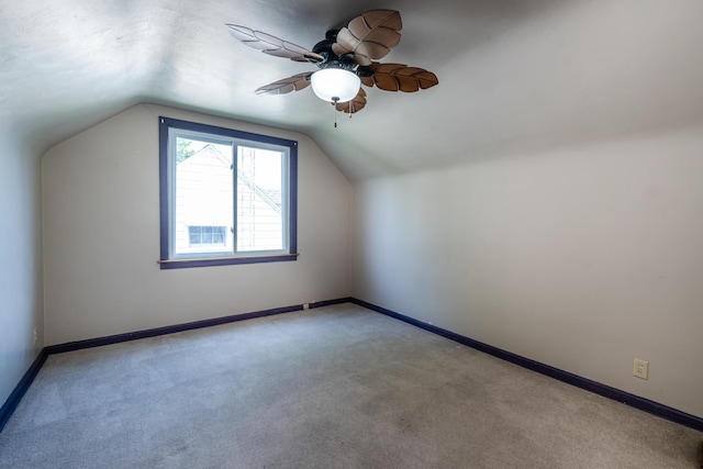 additional living space featuring lofted ceiling, light colored carpet, and ceiling fan