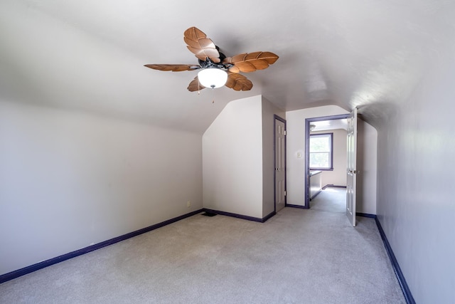 bonus room with lofted ceiling, light colored carpet, and ceiling fan