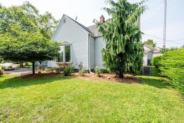 view of side of home featuring a lawn