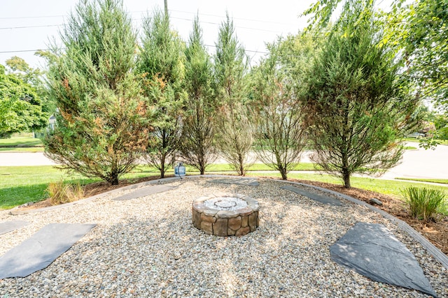 view of yard with an outdoor fire pit